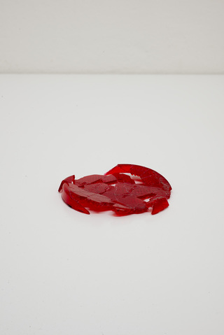 collapsing certainty  2015
Reconstructed and collapsed incomplete collection of plastic fragment remains from a red hella rear signal lamp found in Berlin Mitte 
10 x 10 cm 