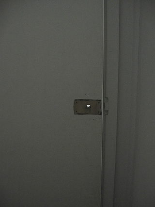 Removed Closure, 2006</br>
Vacant/Engaged toilet door fixture removed from the artist studio at Gertrude Contemporary, Melbourne, to be featured in an exhibition in the same building, then kept for inclusion in the 'Private Collection', 8 x 4.5 x 3 cm